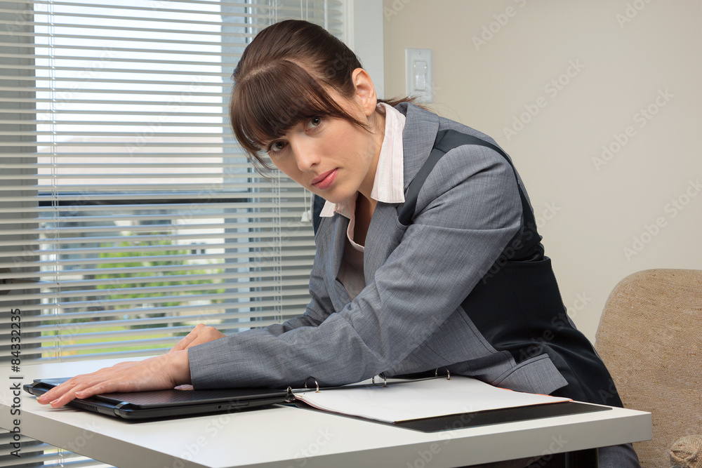 The image of business woman in an office The image of business woman in an office