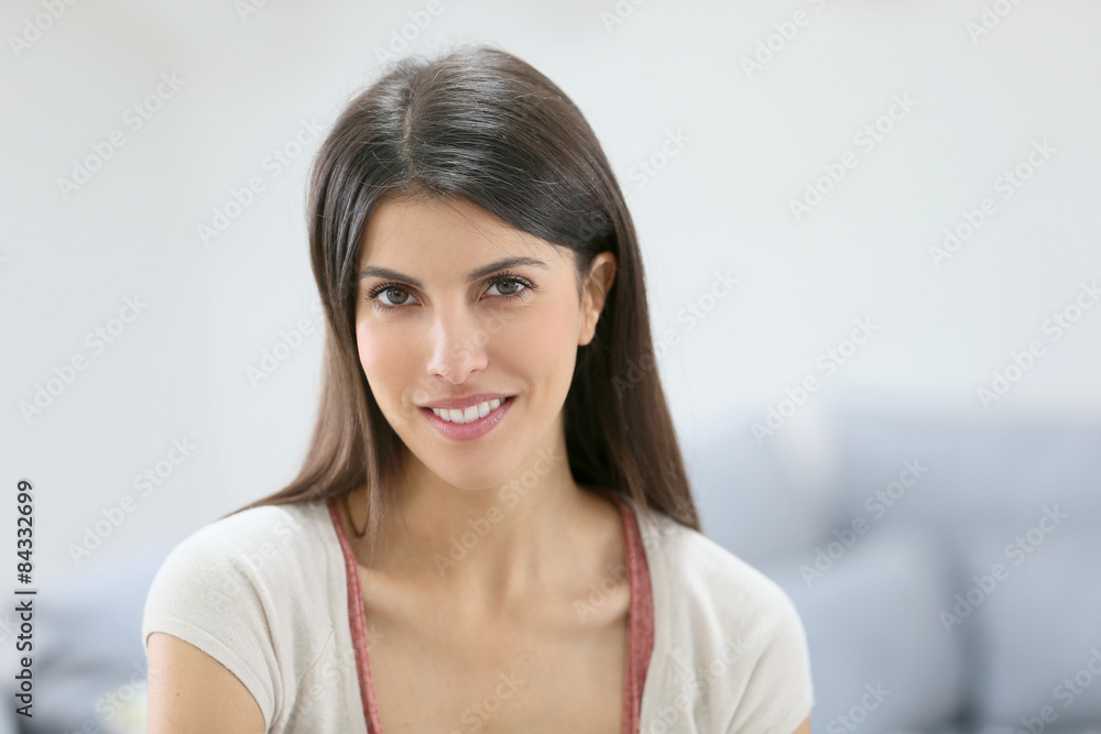 Portrait of brunette girl sitting in sofa at home Portrait of brunette girl sitting in sofa at home