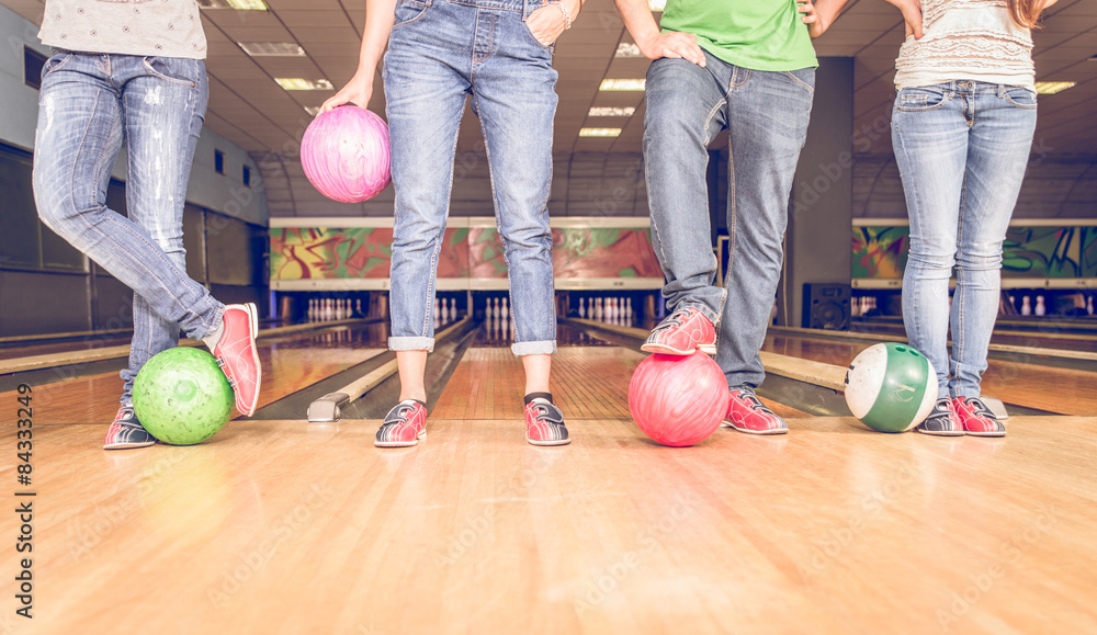 Fototapeta premium scene with four people and bowling balls