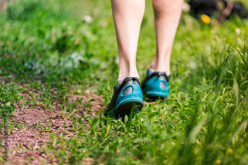 Closeup of running shoes of woman barefoot. © len44ik
