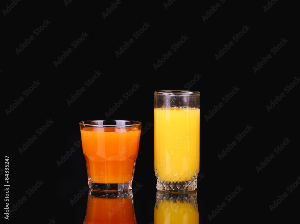 orange and carrot juice on a black orange and carrot juice on a black