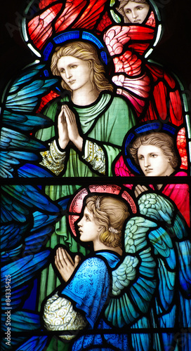 Praying angels in a stained glass window
