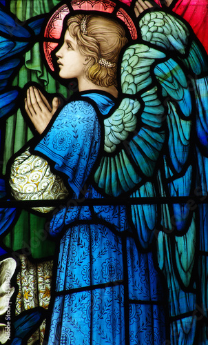 Praying angel in a stained glass window