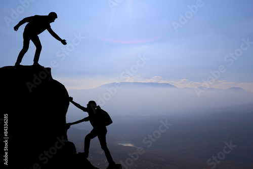 Teamwork couple hiking help each other trust assistance