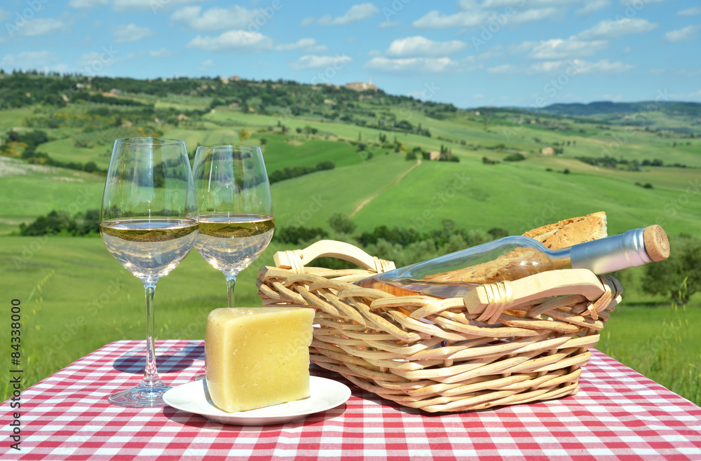 White wine, cheese and bread on the chequered cloth against Tusc