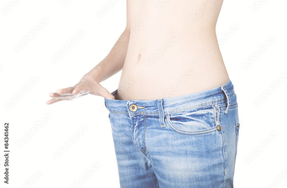 Pancia di donna dimagrita con jeans larghi Stock Photo | Adobe Stock