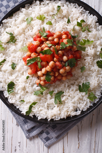 Rice with chickpea and parsley close-up. vertical top view