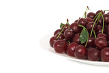 Plate of ripe cherry with water drops (isolated)