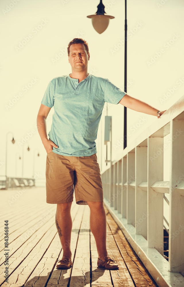 Handsome man tourist on pier. Fashion summer.