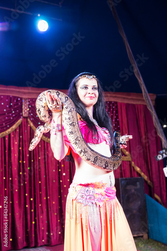 Exotic Belly Dancer Holding Large Snake on Stage