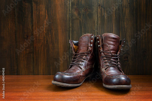 Vintage military boots on wooden background