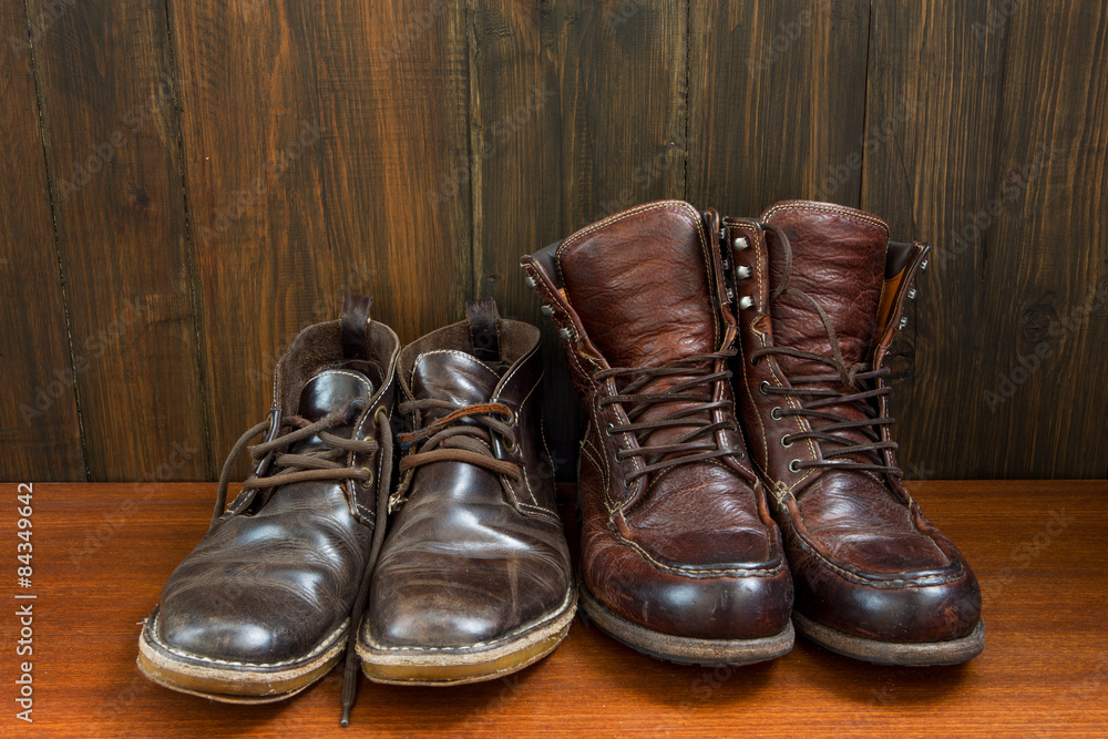 Set of old boots on wooden background