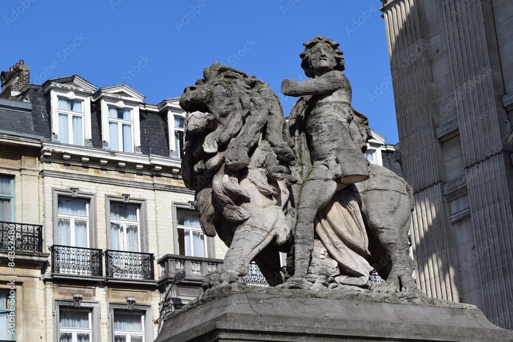 Lion and boy with one leg, one arm statue in Brussels, Belgium
