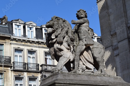 Lion and boy with one leg, one arm statue in Brussels, Belgium
