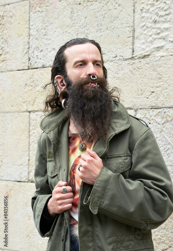 Pierced Men in front of a Wall photo