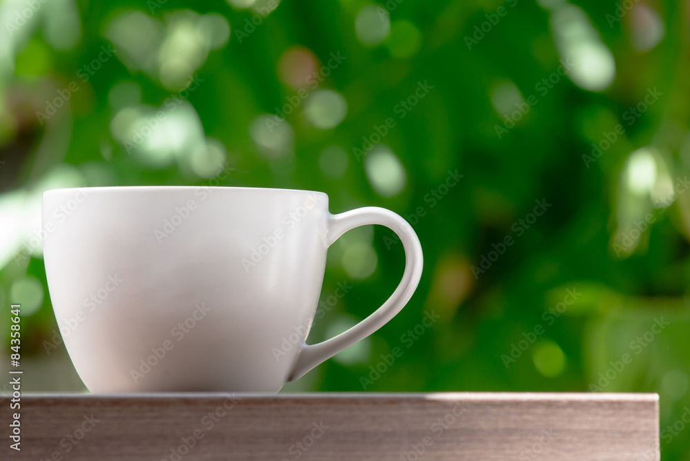 coffee on the wood and green background