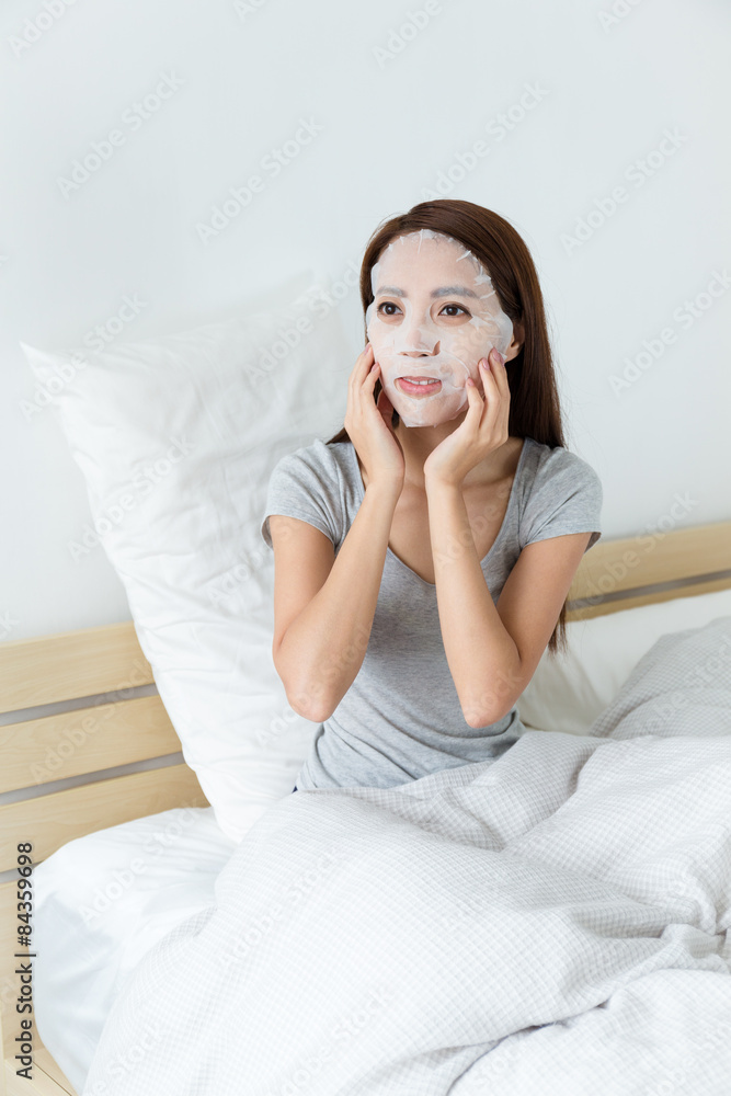 Young lady do masking on bed Young lady do masking on bed