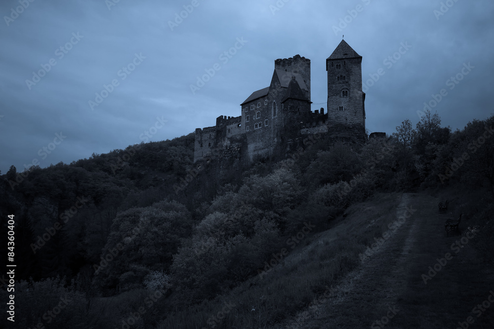 Medieval castle at night with stormy sky