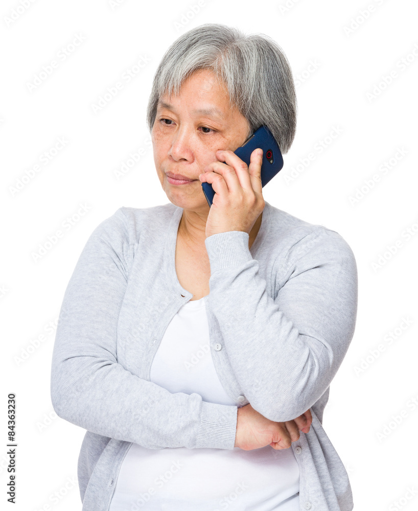 Mature woman talk to smart phone Mature woman talk to smart phone