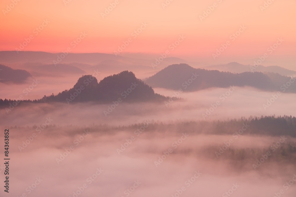 Fogy red daybreak. Misty  beautiful hills and peaks in Sun rays