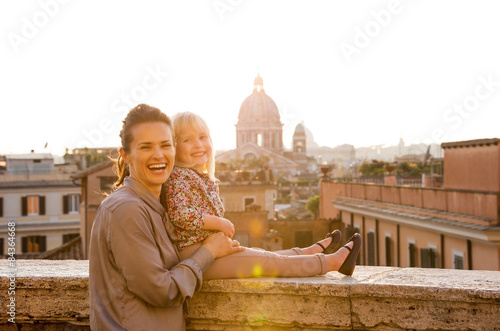 Canvas Print Smiling mother and daughter at sunset in Rome, St. Peter's