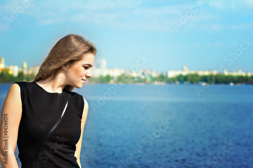 Portrait of young beautiful blonde girl. Stay near water