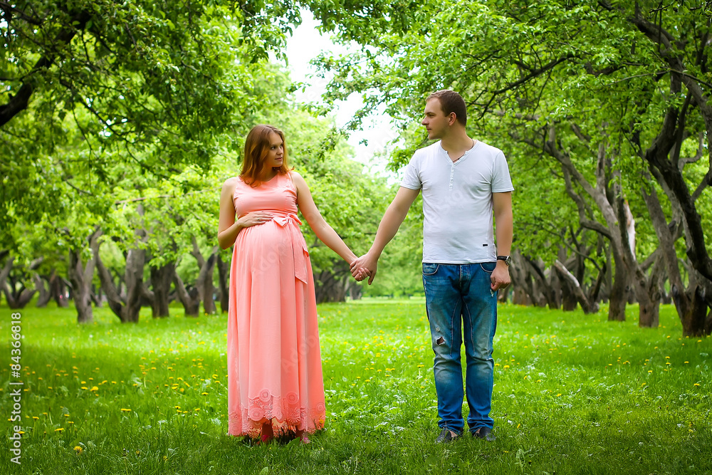 Pregnant woman with man at park Pregnant woman with man at park