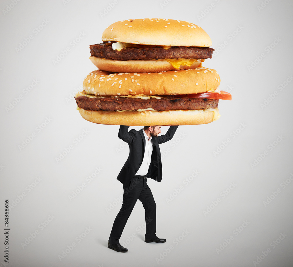 small man carrying big sandwiches