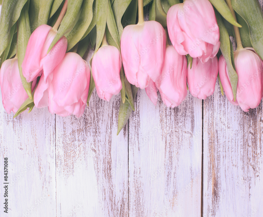 Pink tulips over wooden table - obrazy, fototapety, plakaty 