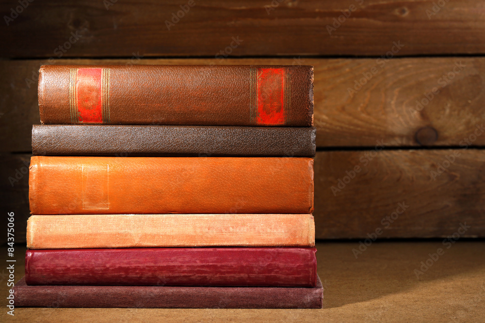 Old books on shelf, close-up, on dark wooden background Old books on shelf, close-up, on dark wooden background