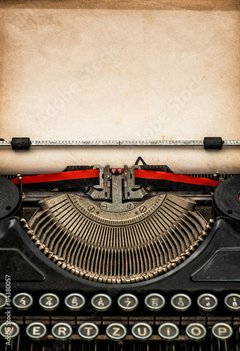 Antique typewriter with aged textured paper sheet