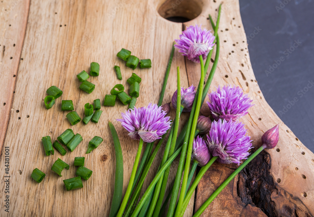 Fototapeta premium Bunch of fresh chives on a wooden table