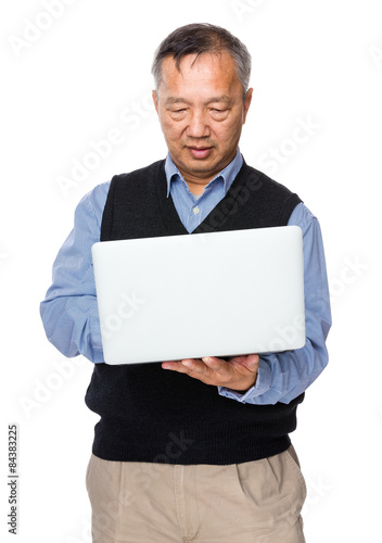 Asian old man use of laptop computer