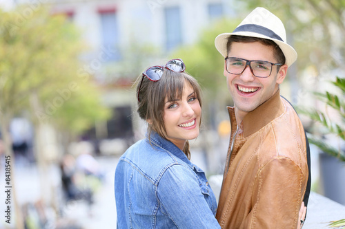 Portrait of trendy young couple in city street