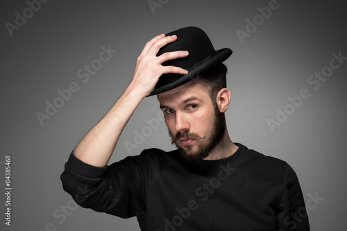 Young man raising his hat  in respect and admiration for someone