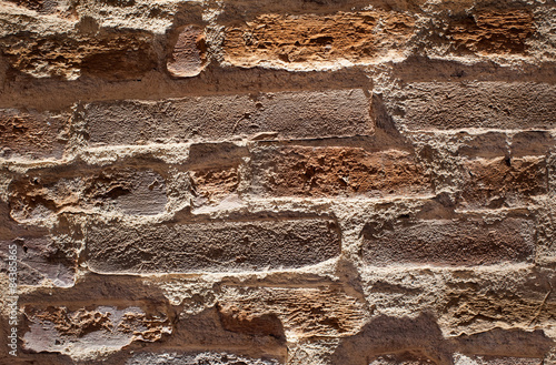 Brick wall background. Artistic and dramatic view of a brick wall using lights and shadows, customizable background.