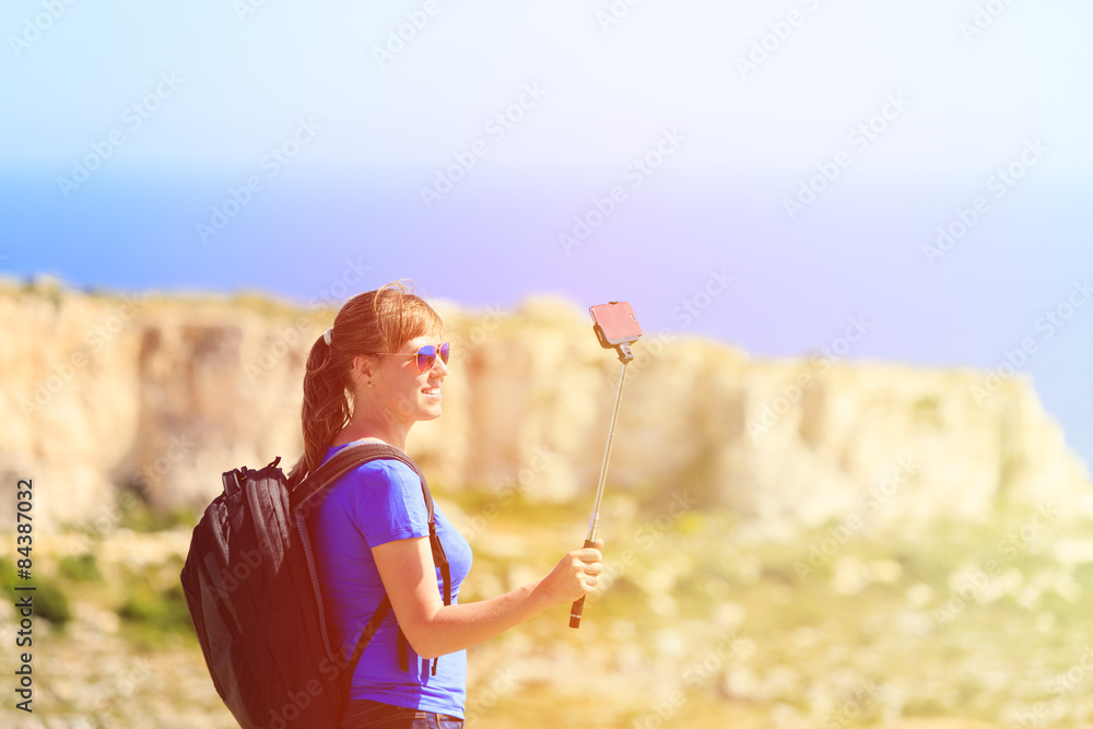 Fototapeta premium tourist making selfie photo on mountains travel