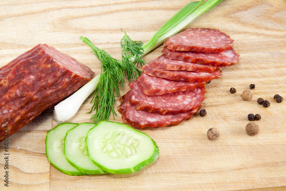 salami sausages on wooden board isolated