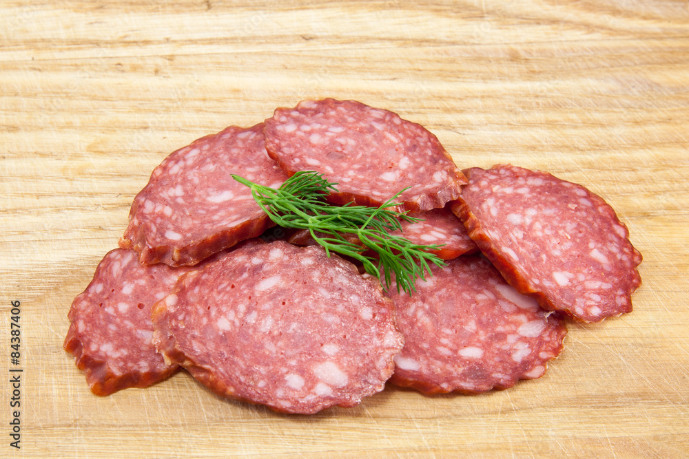 salami sausages on wooden board isolated