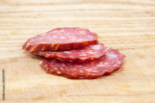 salami sausages on wooden board isolated