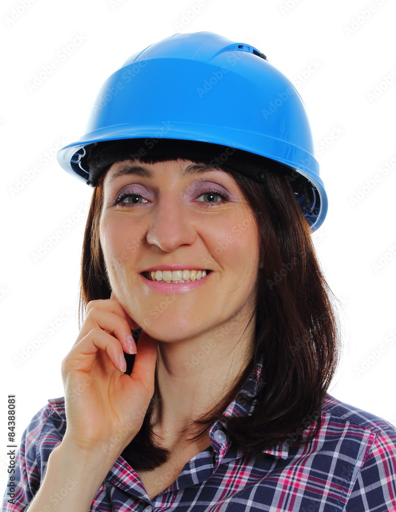 Smiling builder woman wearing protective blue helmet