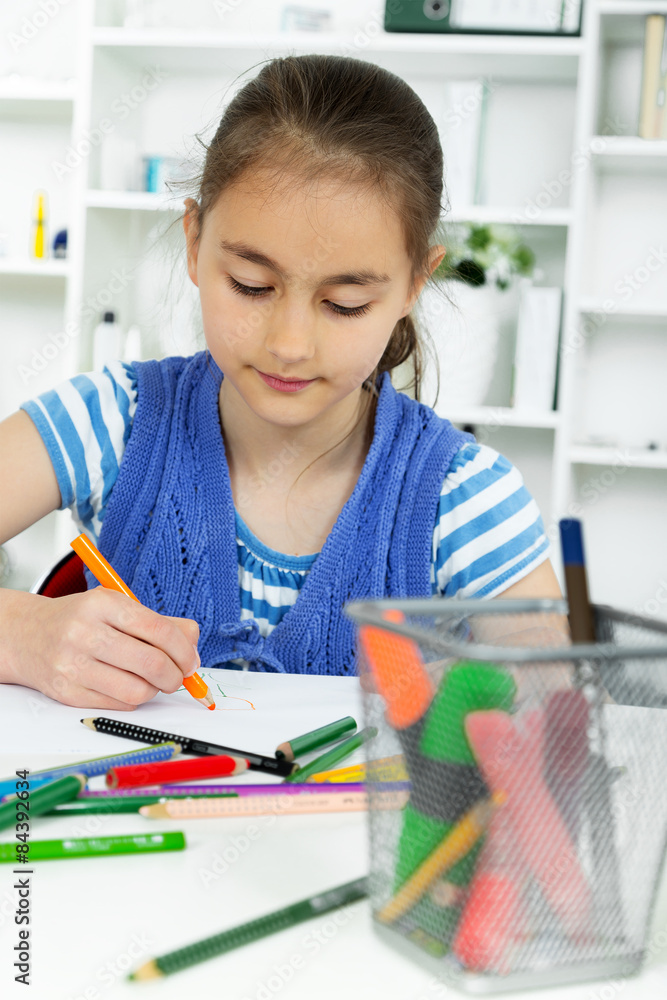 young girl working on her school project at home. young girl working on her school project at home.