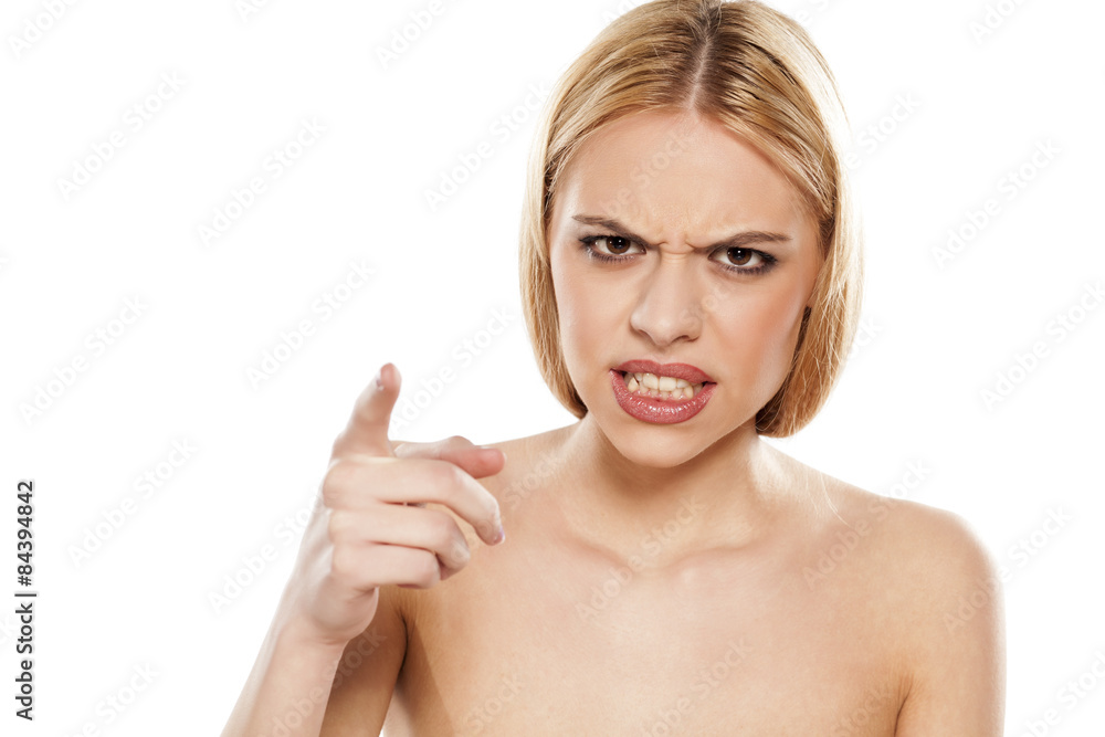 angry young woman pointing a finger at you angry young woman pointing a finger at you