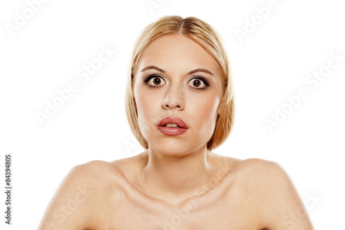 startled young woman on a white background