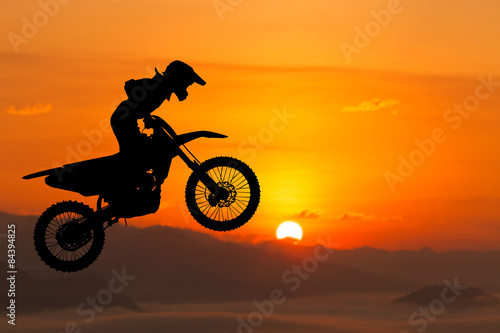 silhouette of biker jumping