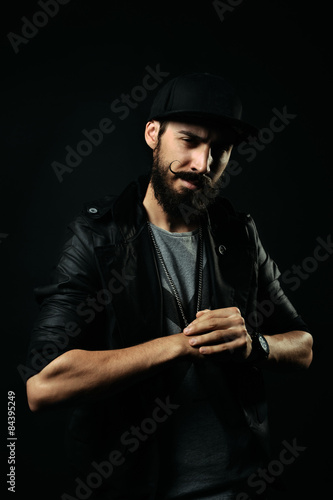 The bearded man in a jacket flexing his fists