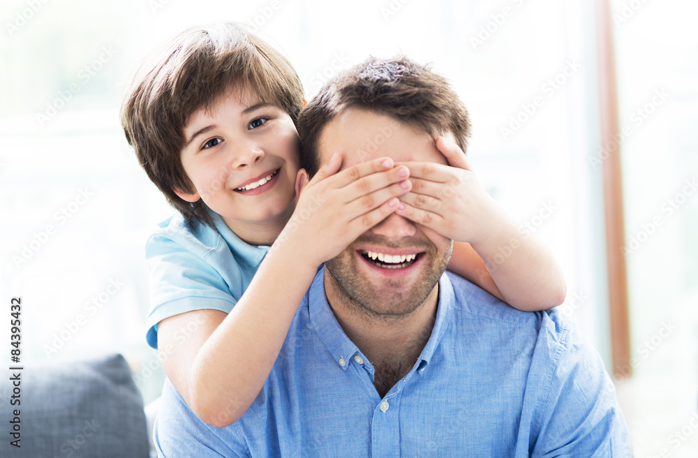 Fototapeta premium Boy covering father's eyes