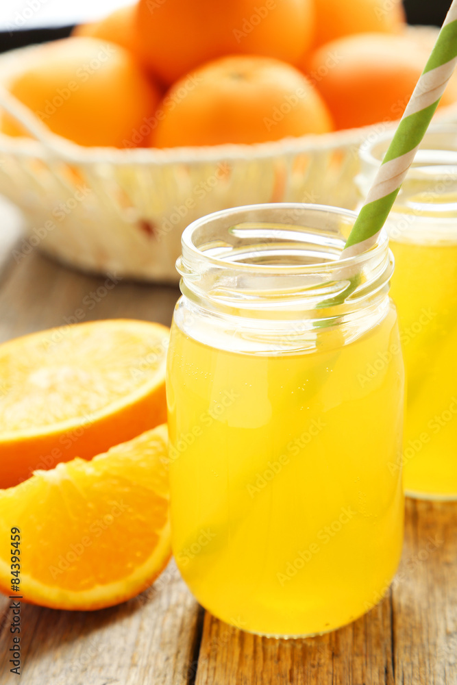 Orange juice in bottle on grey wooden background Orange juice in bottle on grey wooden background