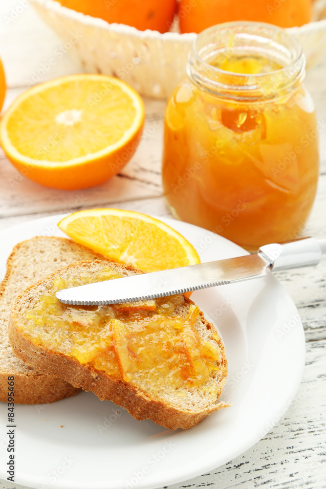 Bread with orange jam on white wooden background Bread with orange jam on white wooden background