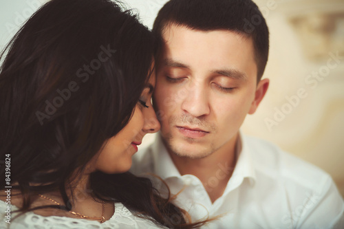 Portrait of a man and a woman face to face with eyes closed